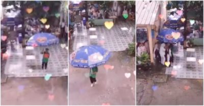 Video chú bảo vệ cầm ô ‘siêu to’ chạy che mưa đưa học sinh sang căn tin trường ăn cơm