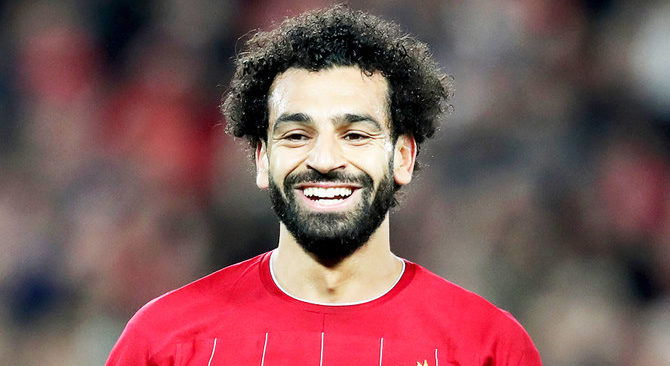 Liverpool's Mohamed Salah smiles after scoring his side's third goal during the Champions League group E soccer match between Liverpool and Red Bull Salzburg at Anfield stadium in Liverpool, England, Wednesday, Oct. 2, 2019. (AP)