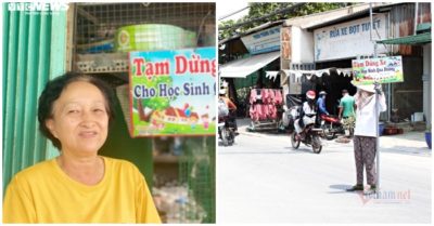 Người phụ nữ cầm bảng đưa học sinh qua đường giữa trưa nắng gắt tại TP. HCM